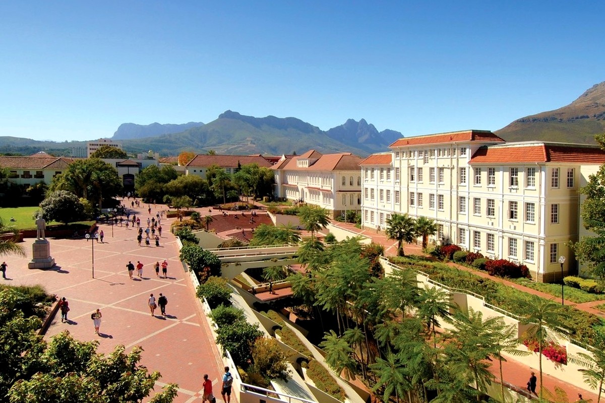 A landscaped garden and broad walking paths beneath clear daylight.